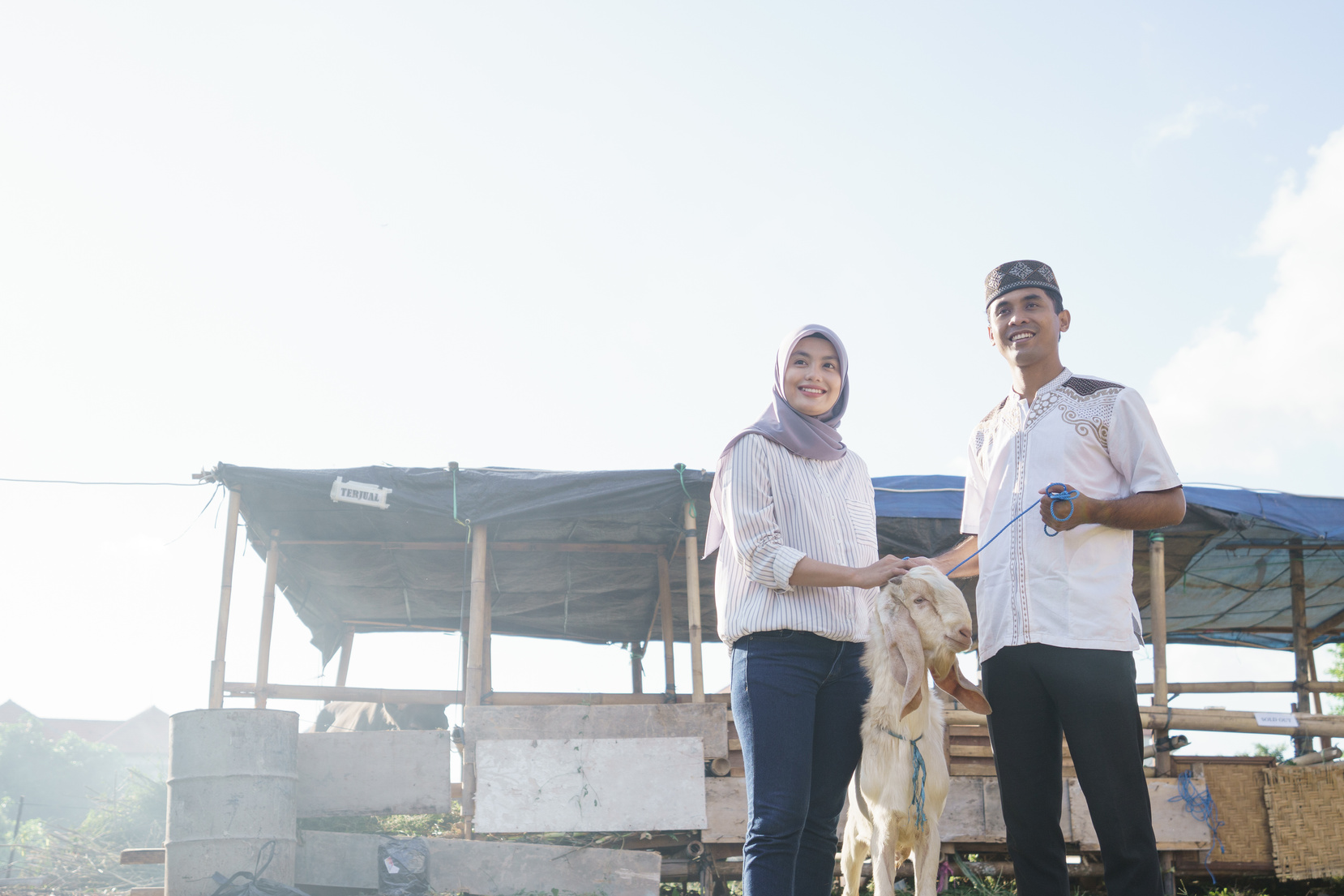 Muslim Couple Buy a Goat for Eid Adha Sacrifice or Idul Qurban